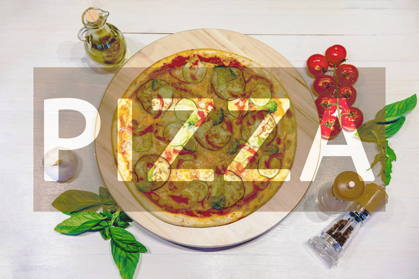 appetizing vegetarian pizza with olive oil, spices and basil leaves on a white table with the inscription "PIZZA", flat lay, toned image - Photo, image