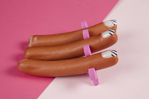 gradient pink background and sausage manicure  - Photo, Image