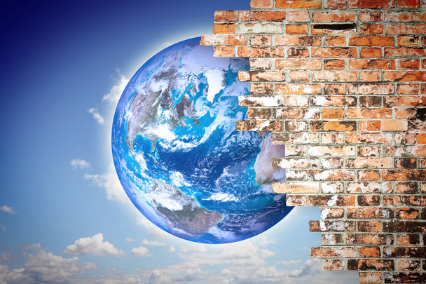 Through a cracked wall you can see the world - freedom concept image - Elements of this image furnished by NASA - Photo, Image