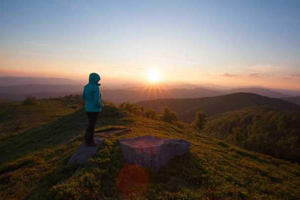 woman in the background of the sunset in the mountains - Photo, Image