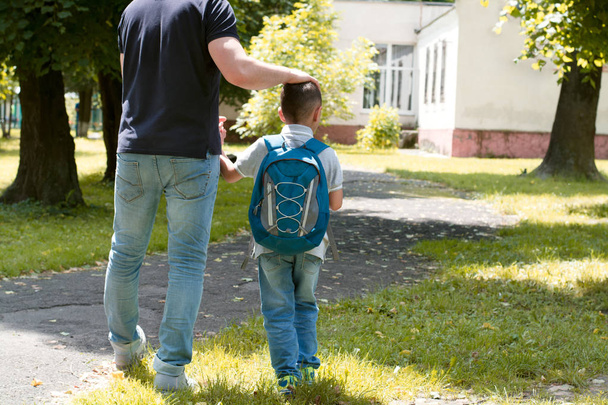 father escorts son to school - 写真・画像