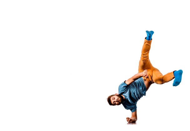Man perform dancing while doing one hand stand - Photo, Image
