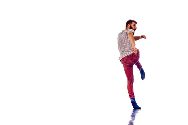 Young man dancing hip-hop at studio - Фото, изображение