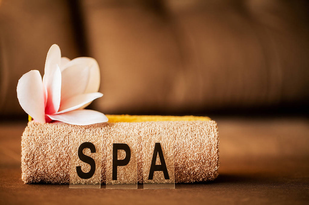Chocolate Spa . Composition brown towel in hotel room of spa treatment - Photo, Image