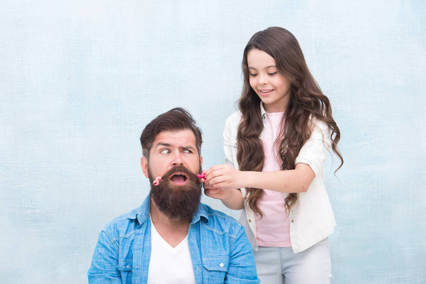 With healthy dose of openness any dad can excel at raising girl. Child making hairstyle styling father beard. Being parent means present for kid interests. Change hairstyle. Create funny hairstyle - Photo, Image