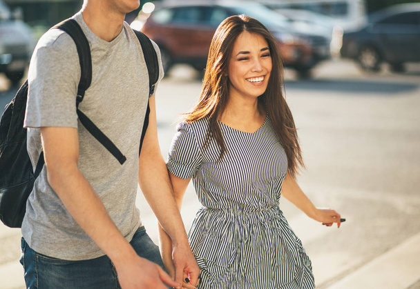 glückliches junges verliebtes Paar Teenager-Freunde in lässiger Kleidung spazieren zusammen auf der Straße der Stadt - Foto, Bild