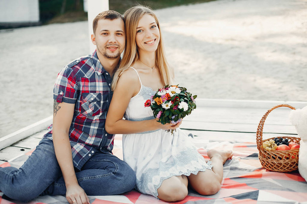Beautiful couple spend time in a summer park - Фото, изображение