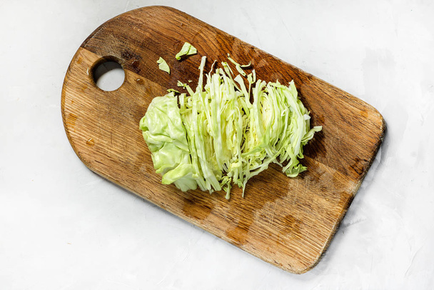 head of fresh young white cabbage. cutting and cooking - Fotoğraf, Görsel