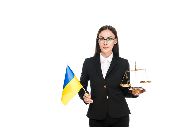 lawyer in black suit holding Ukrainian flag and scales on justice isolated on white - Foto, Imagen