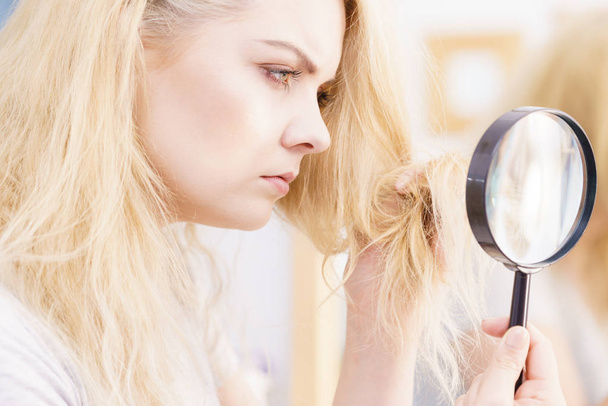 Woman magnifying her split ends hair - Photo, Image