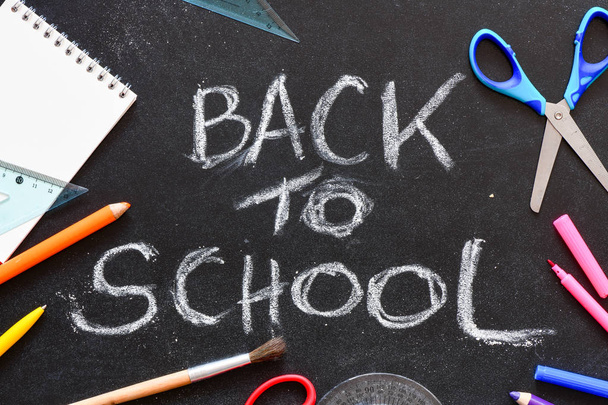 Back to school written on a chalk board.  - Photo, image