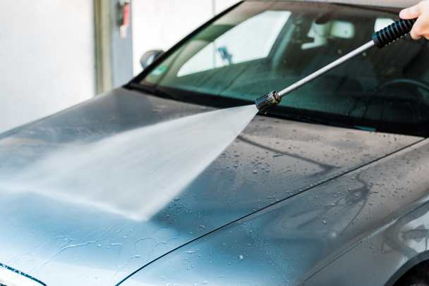 cropped view of car cleaner washing grey auto outside  - 写真・画像