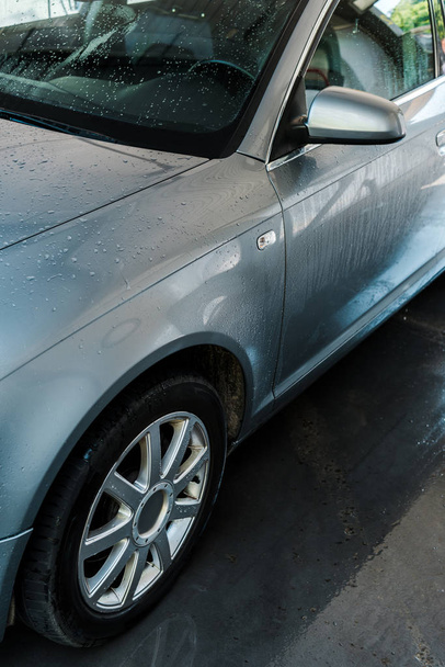 selective focus of drops of water on clean and wet car   - 写真・画像