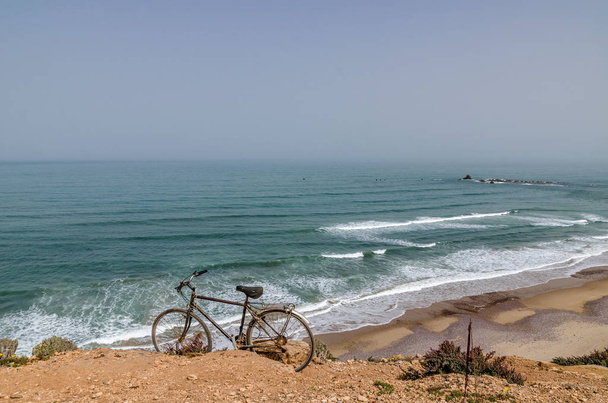 Africa Morocco vintage bike on a hillside on the shores of the Atlantic Ocean - Photo, Image