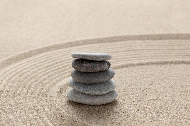 zen stones piled on raked sand with copy space for your text - Photo, Image
