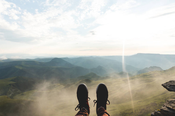 Feet Selfie sport shoes Traveler relaxing on cliff mountains clouds outdoor with aerial view mountains on background Lifestyle hiking Travel concept summer vacations - Фото, зображення
