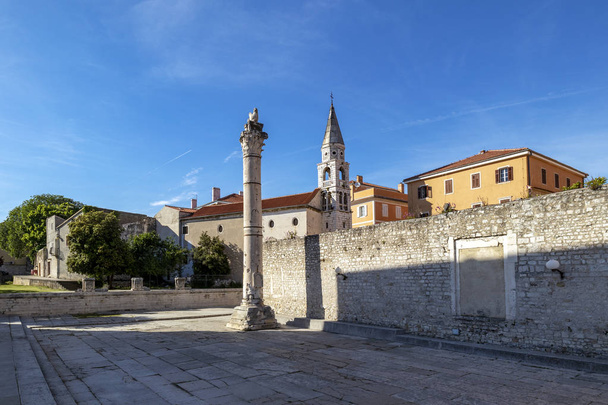 Roman Pillar of Shame and St Elias`s Orthodox Church, in Zadar Old Town, Croatia - Photo, Image