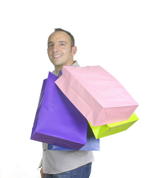 hombre sonriente con varias bolsas de compras
 - Foto, Imagen