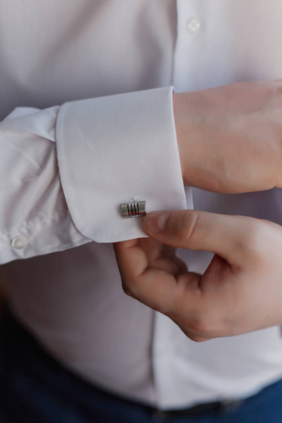 close up of a hand man how wears white shirt and cufflink. - Photo, Image