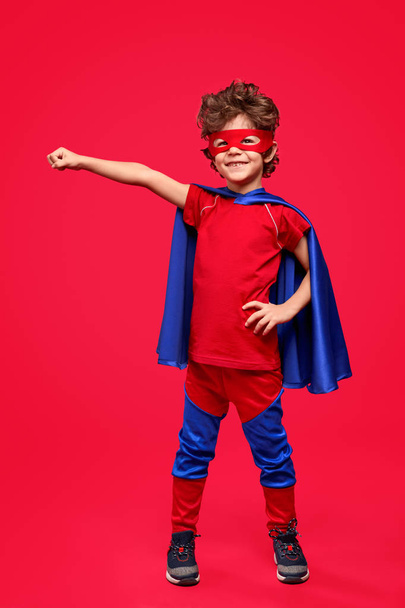 Cheerful superhero in heroic pose - Foto, Bild