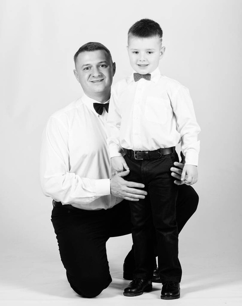 Father and son formal clothes outfit. Grow up gentleman. Dad and boy with bow ties. Gentleman upbringing. Formal event. Little son following fathers example of noble man. Gentleman upbringing - Fotó, kép
