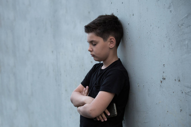 Portrait of a sad teenage boy looking thoughtful about troubles. - Photo, Image