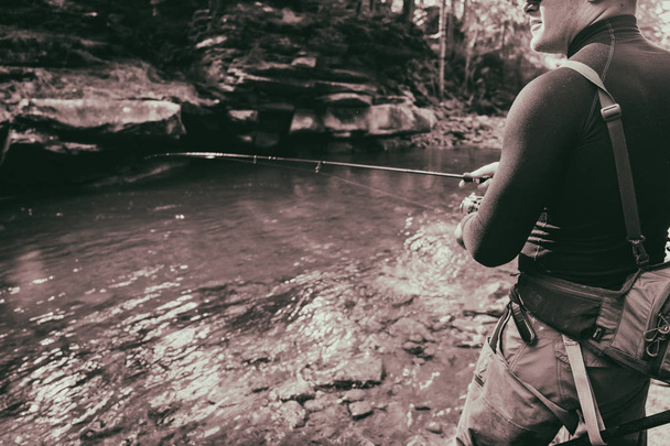 Fisherman on a beautiful mountain river in the forest - Фото, зображення