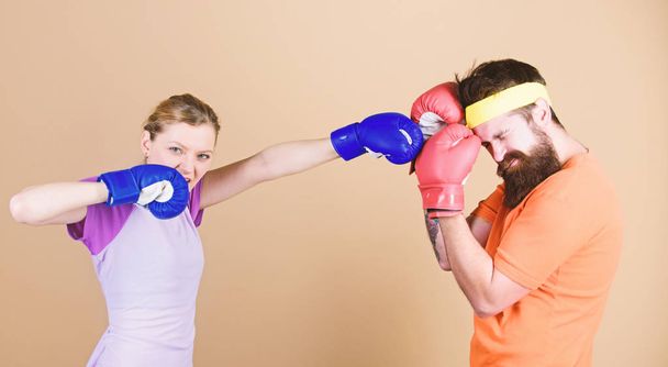 Family battle. Man and woman in boxing gloves. Boxing sport concept. Couple girl and hipster practicing boxing. Sport for everyone. Amateur boxing club. Equal possibilities. Strength and power - Foto, afbeelding