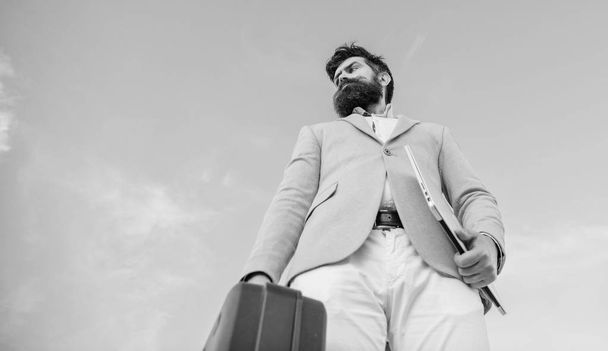 Illegal deal business. Businessman presenting business case. Business man formal suit carries briefcase sky background. Entrepreneur offer bribe. Hipster bearded face hold briefcase with bribe - Fotoğraf, Görsel