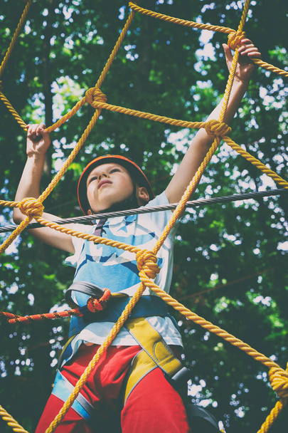 The boy climbs the rope park - Фото, изображение