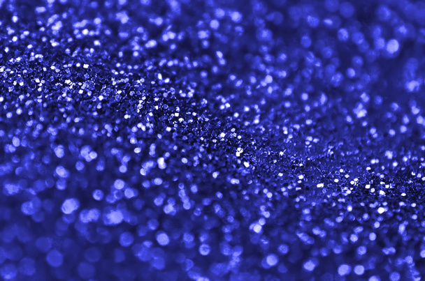 Blue decorative sequins. Background image with shiny bokeh lights from small elements - Photo, Image