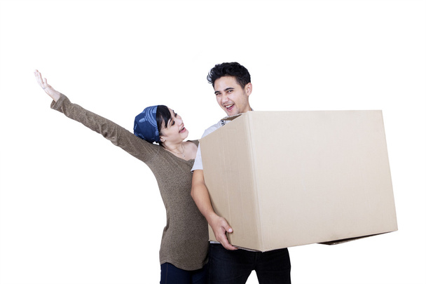 Excited couple bring box - isolated - Zdjęcie, obraz