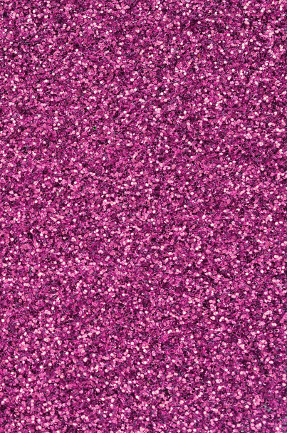 Pink decorative sequins. Background image with shiny bokeh lights from small elements - Photo, Image