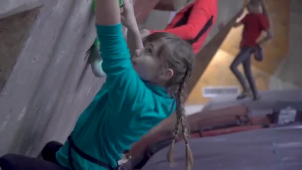 Children train in a climbing gym - Footage, Video