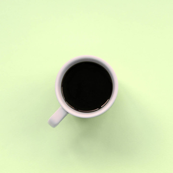 Small white coffee cup on texture background of fashion pastel lime color paper - Foto, imagen