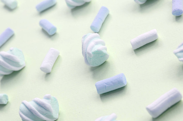Colorful marshmallow laid out on lime paper background. pastel creative textured pattern - Photo, Image