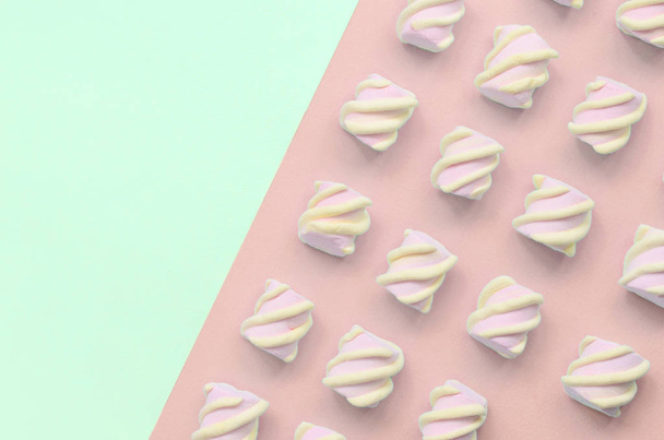 Kleurrijke marshmallow aangelegd op Turquoise en roze papieren achtergrond - Foto, afbeelding