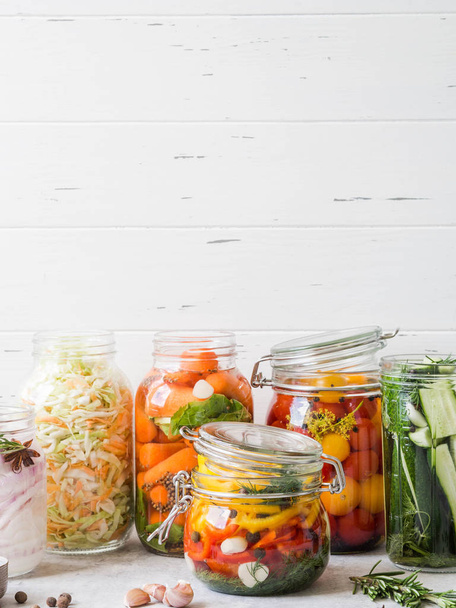 Légumes marinés. Saler divers légumes dans des bocaux en verre pour un stockage à long terme. Conserve les légumes dans des pots en verre. Variété de légumes verts fermentés sur la table
 - Photo, image