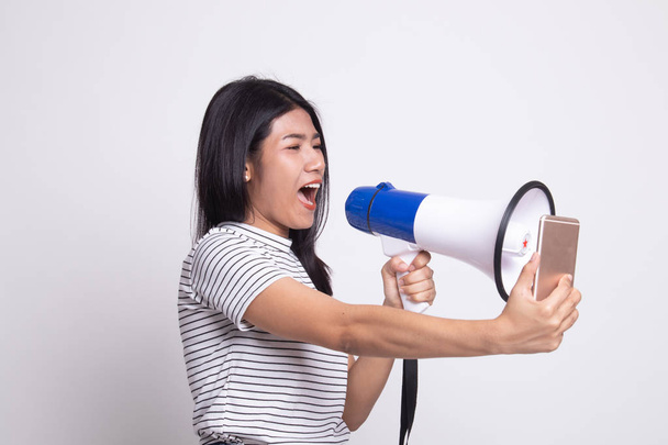 Angry young Asian woman  shout with megaphone to mobile phone. - Foto, imagen