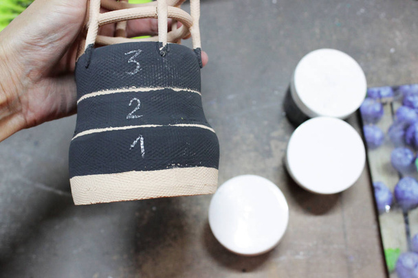 underglaze paint in black color, applied to the once-fired clay pottery. test samples with different concentrations of pigment, numbered - Photo, Image