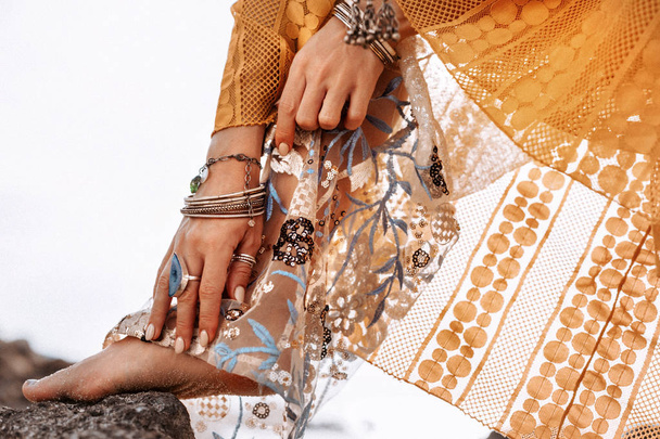 close up of woman hands with boho style accessories outdoors - Фото, изображение