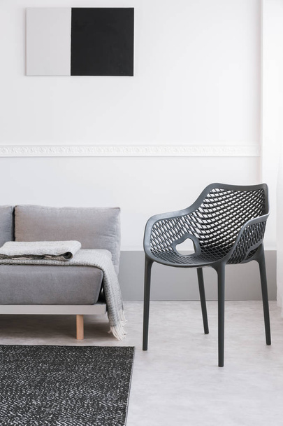 Monochrome living room interior with fancy grey chair and sofa - Фото, зображення