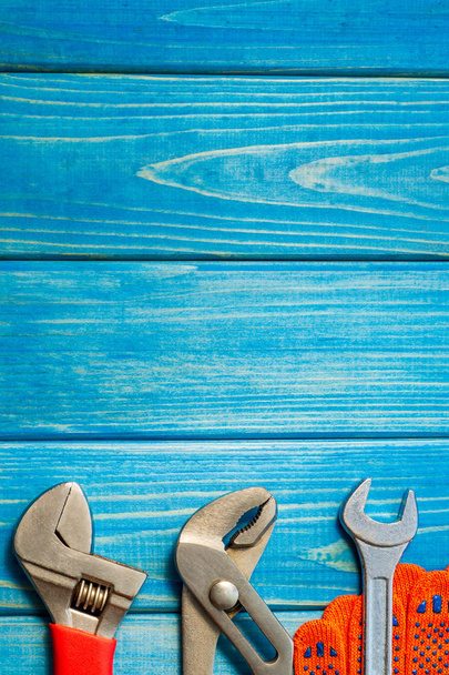 Necessary set of tools for plumbers on a blue wooden background. - Foto, Imagem