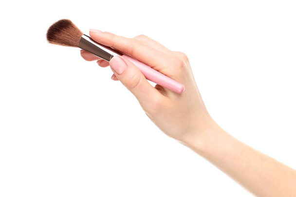 Makeup brush in female hand on white background - Foto, afbeelding