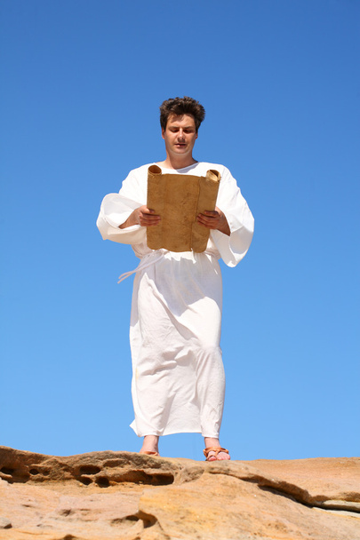 Man in traditional robe reading scroll - Photo, Image
