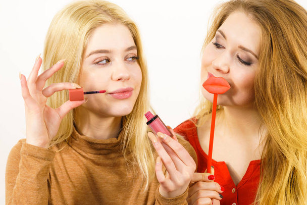 Two women and lip product - Foto, Imagen