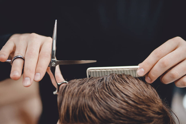 Barbershop, man barber in men hairdresser does hair with scissors - Photo, Image