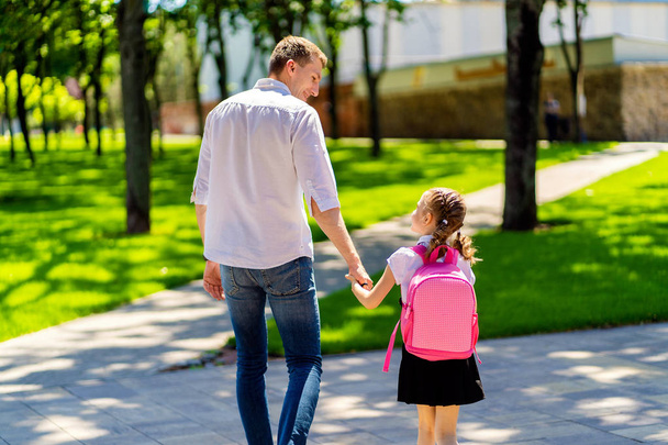 father leads daughter to school in first grade. first day at school. back to school - Fotoğraf, Görsel