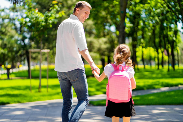 father leads daughter to school in first grade. first day at school. back to school - Foto, Imagen