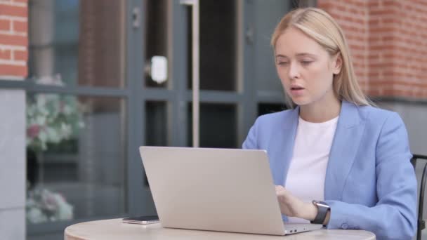 Young Businesswoman with Neck Pain Using Laptop Outdoor - 映像、動画